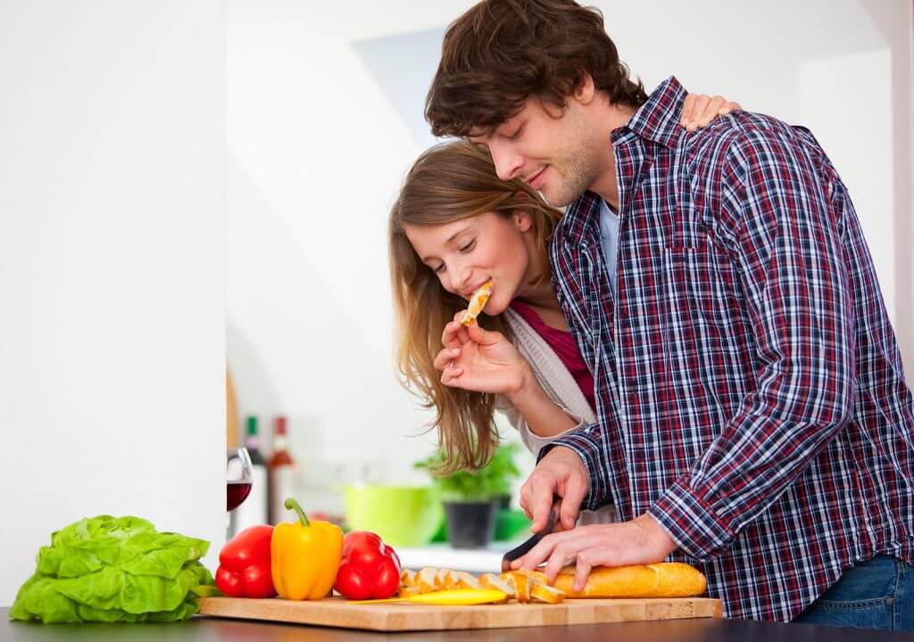 Couple cooking together in kitchen